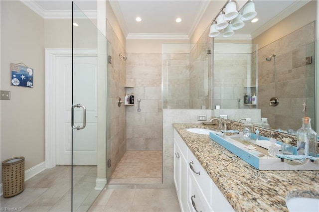 bathroom with vanity, tile patterned flooring, ornamental molding, and a shower with shower door