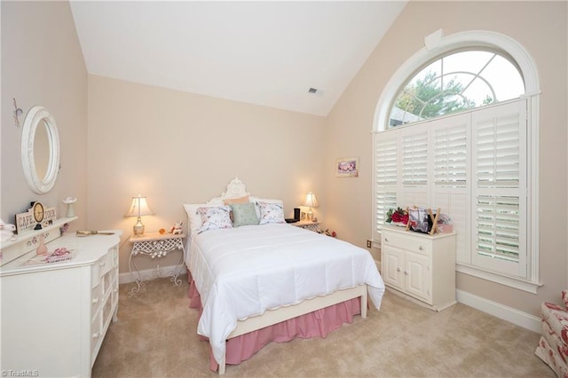 bedroom featuring light carpet and vaulted ceiling