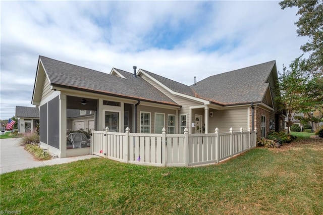 back of house featuring a yard and ceiling fan