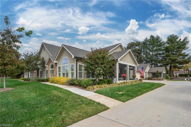 view of front of house featuring a front lawn and a sunroom