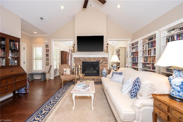 living room with a fireplace, dark hardwood / wood-style floors, ceiling fan, and high vaulted ceiling