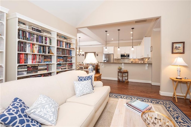 living room with ornamental molding, dark wood-type flooring, and a chandelier