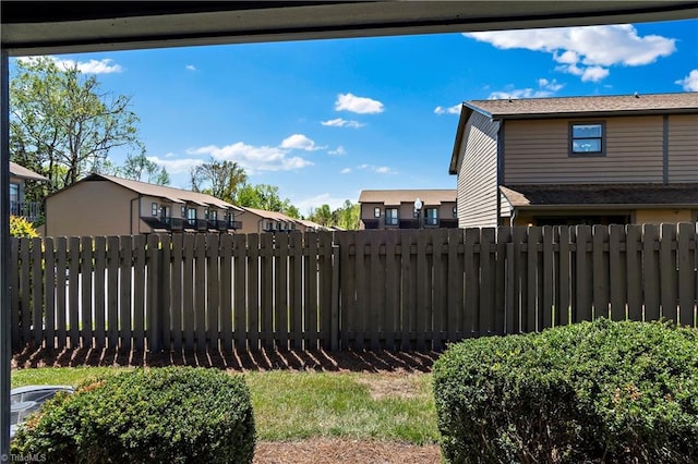 view of yard with fence and a residential view