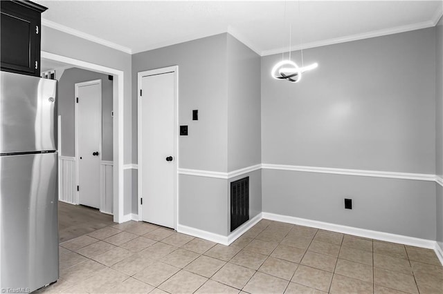 unfurnished dining area with visible vents, ornamental molding, and light tile patterned floors
