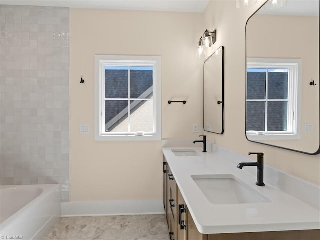 bathroom featuring a sink, baseboards, and double vanity