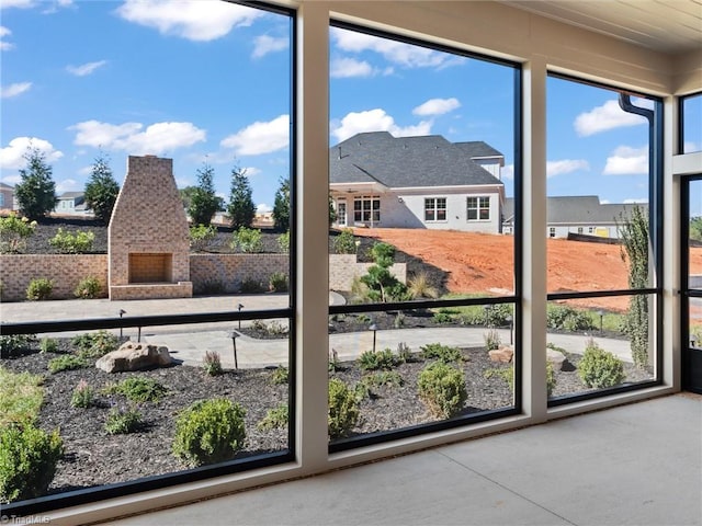 doorway to outside with concrete flooring and a residential view