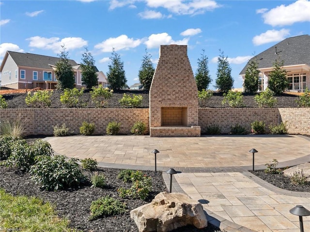 view of patio / terrace with an outdoor brick fireplace