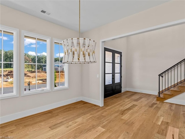 entryway with visible vents, baseboards, stairs, french doors, and light wood-type flooring