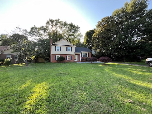 100 Petree Rd, Winston-Salem, NC 27106 - view of front of house with brick siding, a chimney, and a front lawn