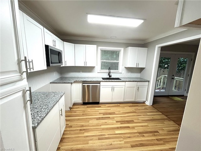100 Petree Rd, Winston-Salem, NC 27106 - kitchen with stainless steel appliances, light stone countertops, ornamental molding, white cabinets, and light wood-style floors