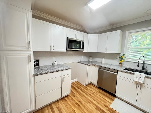 100 Petree Rd, Winston-Salem, NC 27106 - kitchen with stainless steel appliances, light stone counters, white cabinets, backsplash, and light wood finished floors
