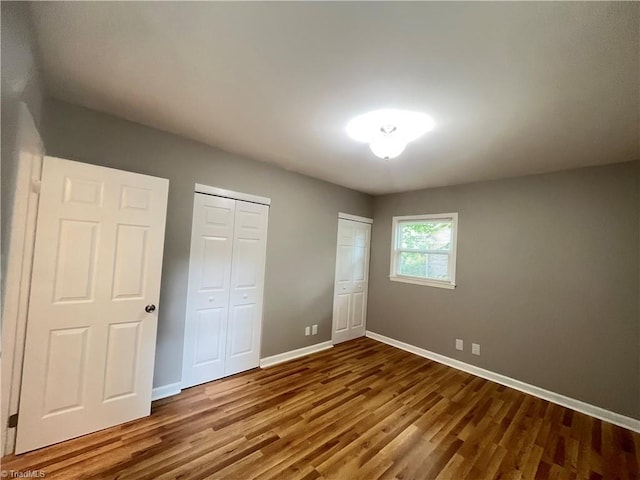 100 Petree Rd, Winston-Salem, NC 27106 - unfurnished bedroom with wood finished floors and two closets