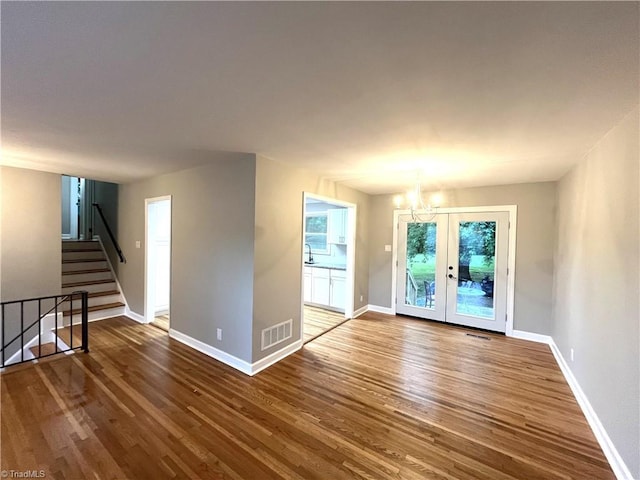 100 Petree Rd, Winston-Salem, NC 27106 - spare room with wood finished floors, a chandelier, french doors, and stairs