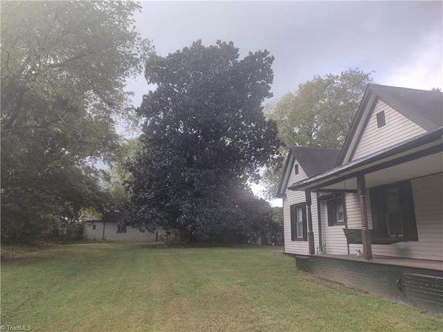 view of yard with covered porch