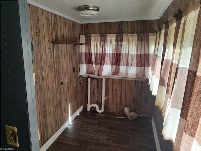 misc room with wood walls and dark wood-type flooring