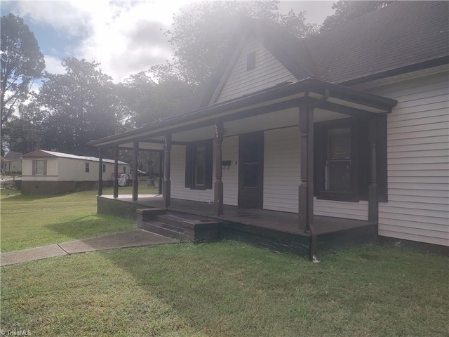 view of front of property with a porch and a front yard