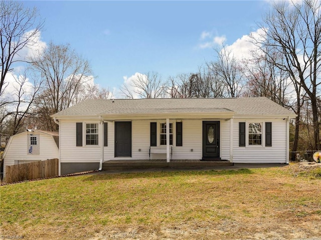 ranch-style home featuring a porch, a front yard, fence, and a shingled roof