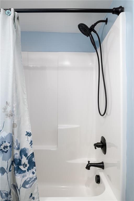 bathroom featuring shower / bath combo with shower curtain