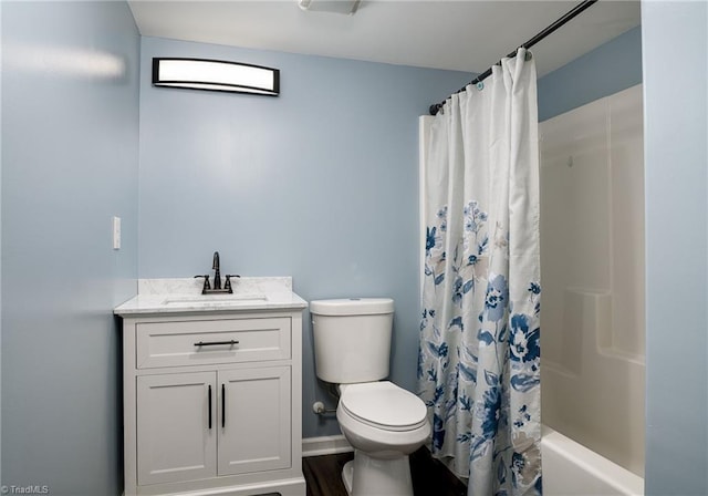 bathroom with shower / bath combination with curtain, vanity, and toilet