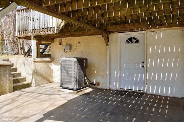 property entrance featuring cooling unit and a patio