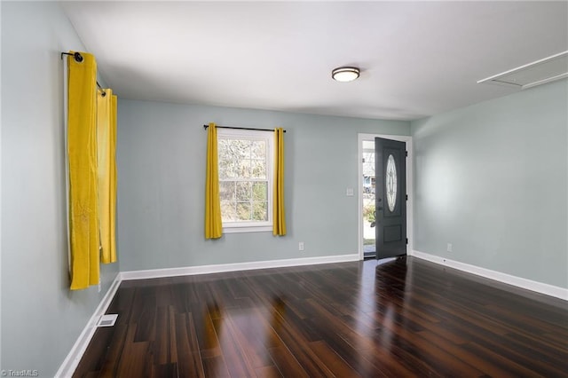 foyer entrance featuring baseboards and wood finished floors