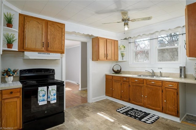 kitchen with a sink, under cabinet range hood, open shelves, and black range with electric stovetop