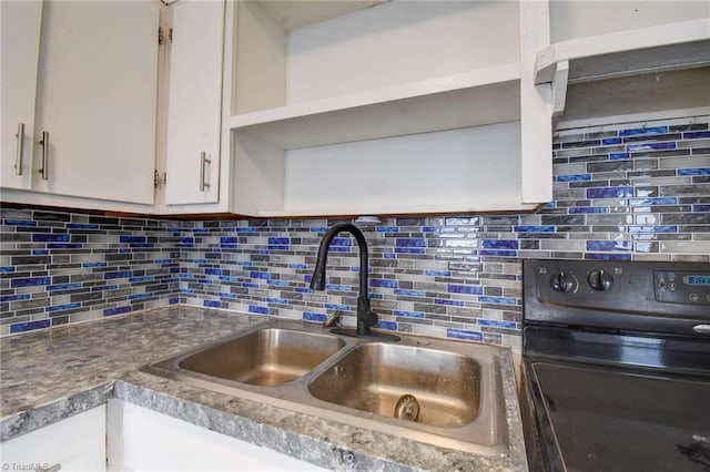 kitchen with tasteful backsplash, sink, white cabinetry, and black range with electric cooktop