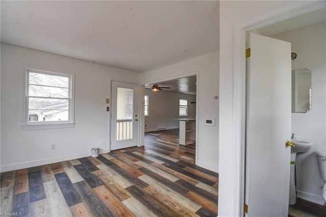 foyer with dark wood-type flooring and ceiling fan