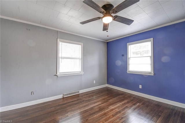 spare room featuring crown molding, ceiling fan, dark hardwood / wood-style floors, and a wealth of natural light