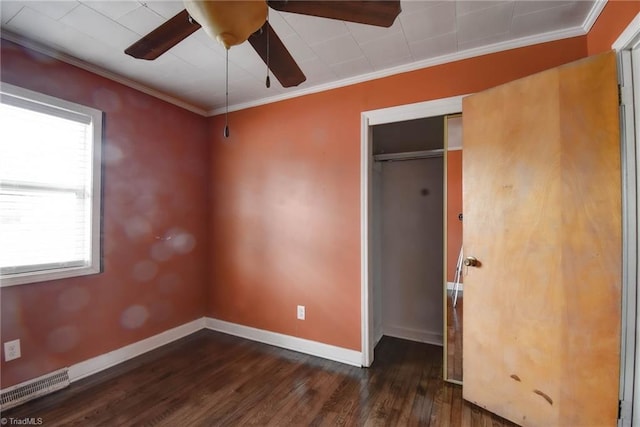 unfurnished bedroom featuring dark hardwood / wood-style flooring, crown molding, a closet, and ceiling fan