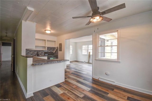 kitchen featuring tasteful backsplash, white cabinetry, dark hardwood / wood-style flooring, and kitchen peninsula