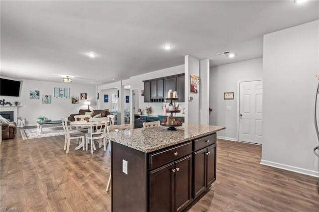 371 Royce Dr, Winston-Salem, NC 27107 - kitchen featuring dark brown cabinets, open floor plan, visible vents, and dark wood finished floors
