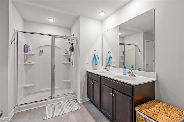 371 Royce Dr, Winston-Salem, NC 27107 - bathroom with double vanity, baseboards, a shower stall, and a sink