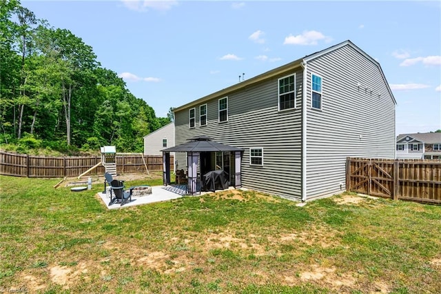 371 Royce Dr, Winston-Salem, NC 27107 - back of property featuring a lawn, a patio area, a gazebo, a fenced backyard, and a fire pit