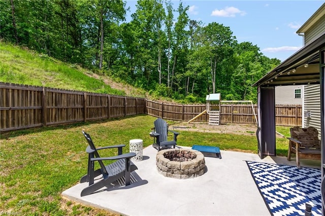 371 Royce Dr, Winston-Salem, NC 27107 - view of patio featuring a fenced backyard, a playground, and an outdoor fire pit