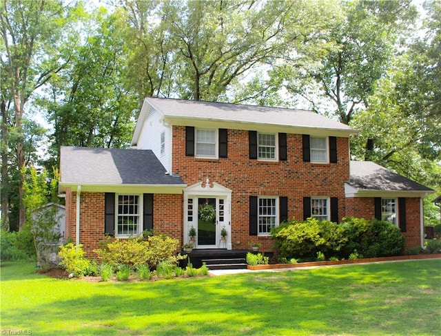 4503 Radnor Dr, Greensboro, NC 27410 - view of front facade featuring a front lawn, brick siding, and roof with shingles