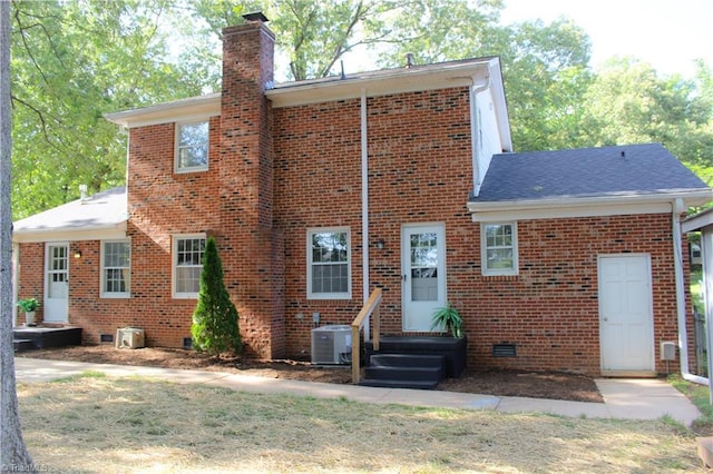 4503 Radnor Dr, Greensboro, NC 27410 - view of front of home with brick siding, a chimney, central AC, and crawl space