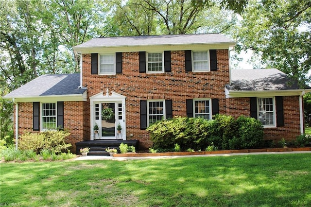 4503 Radnor Dr, Greensboro, NC 27410 - view of front of property featuring a front lawn, roof with shingles, and brick siding