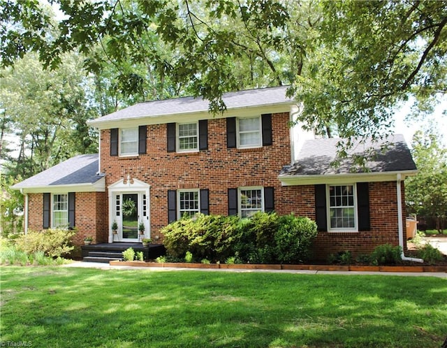 4503 Radnor Dr, Greensboro, NC 27410 - colonial inspired home with a front lawn, brick siding, and a shingled roof