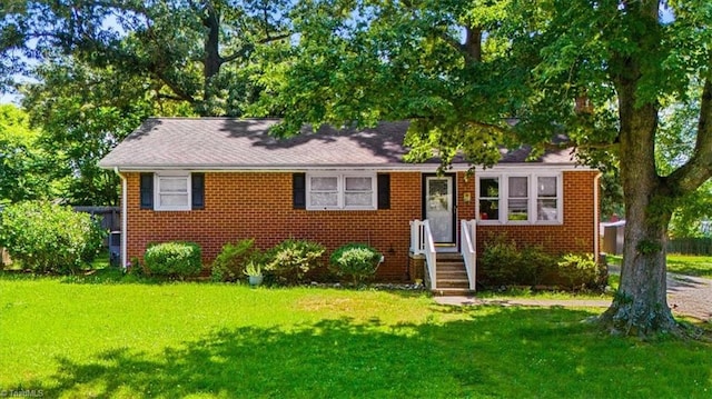 803 Buckner St, Graham, NC 27253 - view of front facade featuring a front yard and brick siding