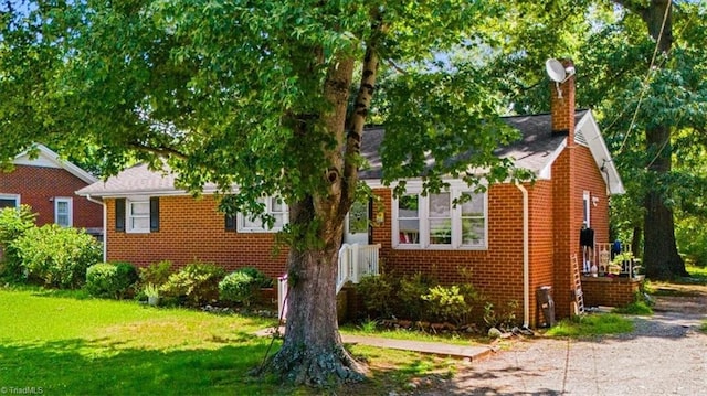 803 Buckner St, Graham, NC 27253 - view of front of property featuring brick siding, a chimney, and a front yard