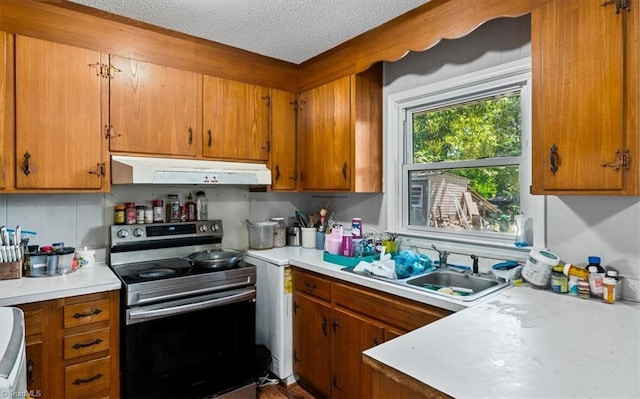 803 Buckner St, Graham, NC 27253 - kitchen with stainless steel electric range oven, ventilation hood, brown cabinets, and a textured ceiling