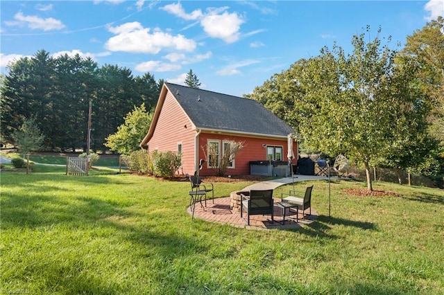 2108 Glenside Dr, Greensboro, NC 27405 - back of property with a hot tub, a patio, and a yard