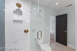 2108 Glenside Dr, Greensboro, NC 27405 - full bathroom featuring a shower stall and baseboards