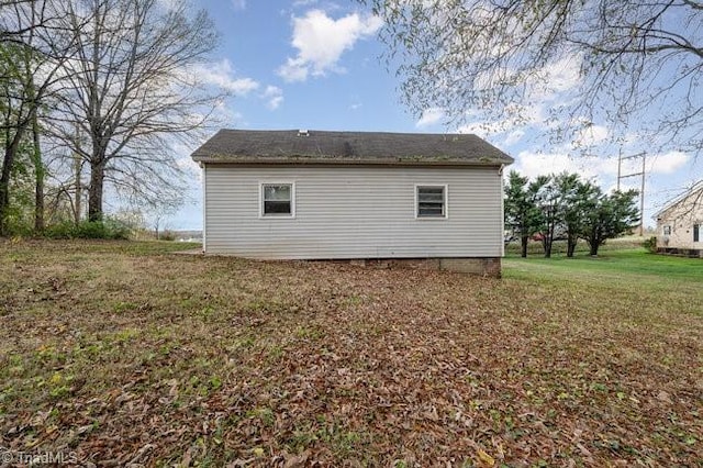 view of side of property with a yard