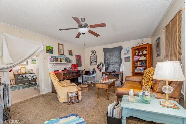 living room with carpet flooring, ceiling fan, and a textured ceiling