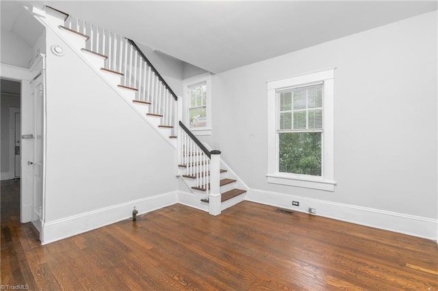 stairway with hardwood / wood-style floors