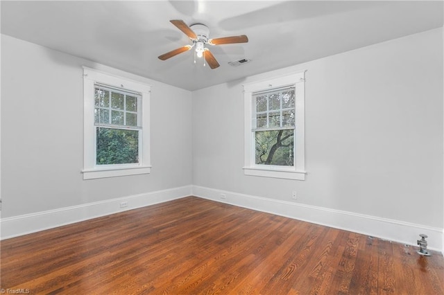 spare room with hardwood / wood-style flooring, plenty of natural light, and ceiling fan