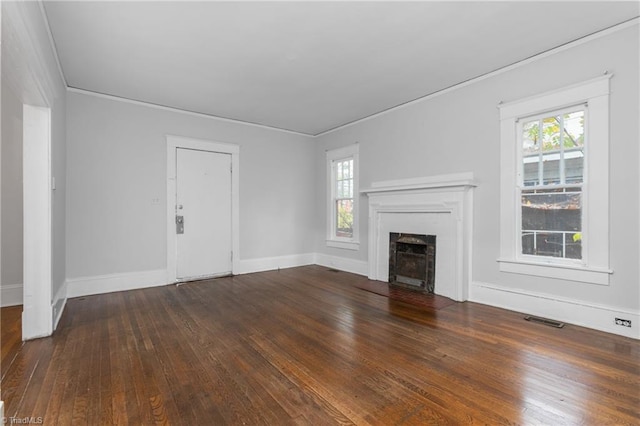 unfurnished living room featuring dark hardwood / wood-style floors and plenty of natural light