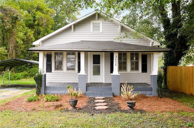 view of front of home featuring covered porch and a carport